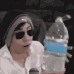 man in beanie drinking from water bottle