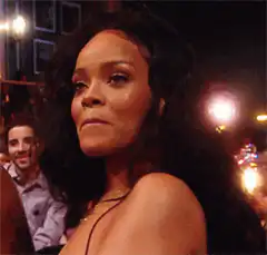 Rihanna smirking at a party