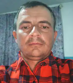 Man in red plaid shirt looking at camera
