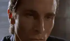 Bruce Wayne examining a card