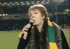 Woman singing Where Are You at a stadium