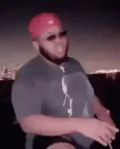 DJ Khaled and friend high-fiving on a boat