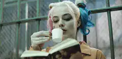 Harley Quinn drinking from a cup