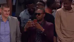 Damian Lillard holding two phones