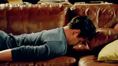 Man faceplants into couch pillow