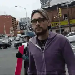 Man in purple hoodie gets hit by skateboard