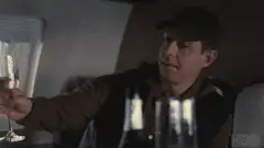 Tony Soprano and Christopher Moltisanti toast on a plane