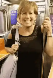 Woman on subway smiling and laughing