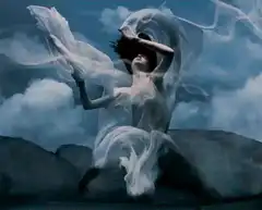 Woman in white dress dancing in wind