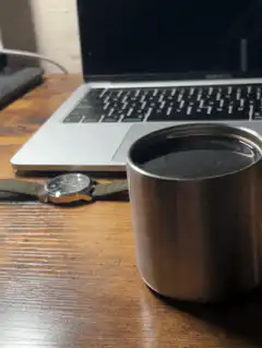 coffee cup on desk with laptop