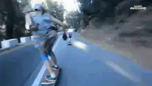 Longboarder carving downhill with hand down
