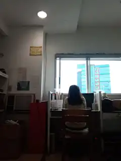 Girl sitting at desk looking out window