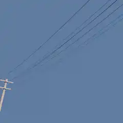 Utility pole against blue sky