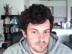 Man in grey hoodie looking at camera