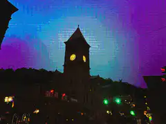 glitchy clock tower at night
