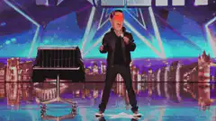 Man dancing on stage with Bitcoin logo