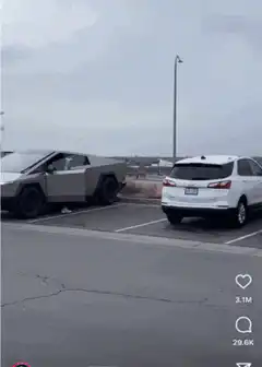 Man in VR headset walks past Tesla Cybertruck