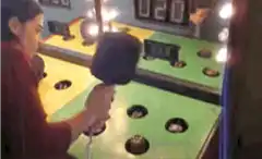 Woman playing arcade whack-a-mole game