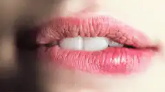 Close-up of pink lips with teeth