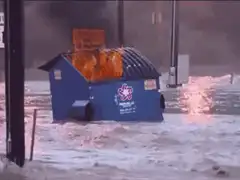 blue dumpster on fire in snow