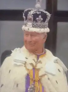 King Charles III smiling in crown