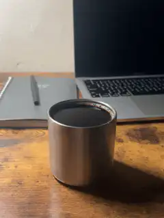 steaming metal cup on desk