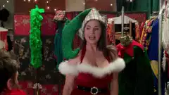 Woman in elf costume tries on Santa hat