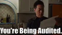 Man reading paper You're Being Audited