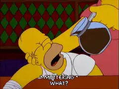 Homer Simpson muttering what coffee poured in mouth