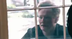 Woman looking through window