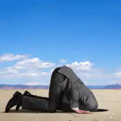 Man burying head in sand ignorance is bliss