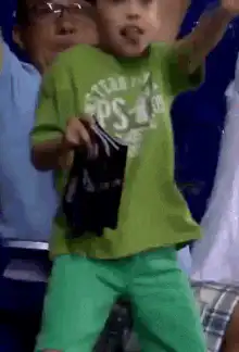 Excited boy rips shirt at game