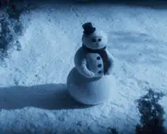 snowman waving in snow