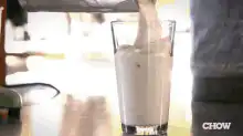 Pouring thick white liquid into glass