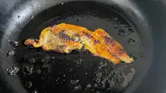 bacon frying in pan