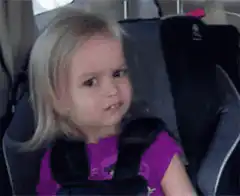 Blonde girl in car seat making a face