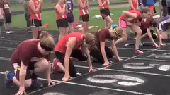 Girl trips at start of track race