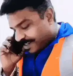 Man on phone shushes camera