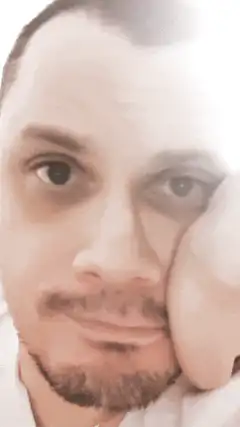 Man resting cheek on hand