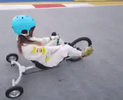 Girl riding a go-kart on a track