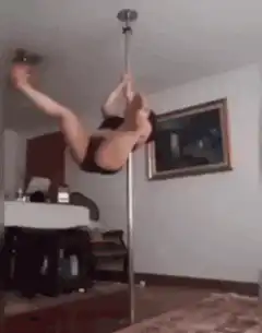 Woman pole dancing falls over