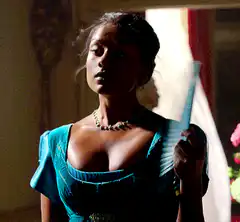 Woman in blue dress fanning herself