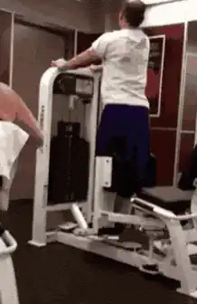 Man doing leg raises on gym machine