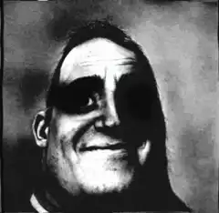 Grainy black and white face with dark eye patch