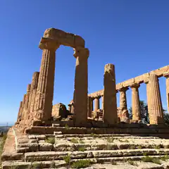 Ancient Greek temple ruins under blue sky