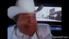 John Candy laughing in car