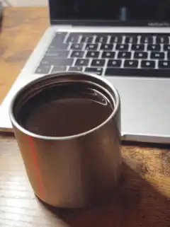 coffee mug on desk with laptop