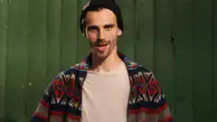 Man in beanie gives the finger
