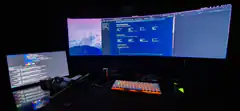 dark room with triple monitor setup