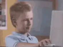 Boy gives thumbs up to computer